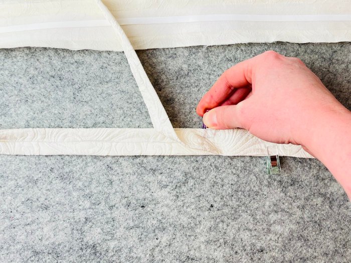 Placing two laptop strap pieces on top of each other before sewing