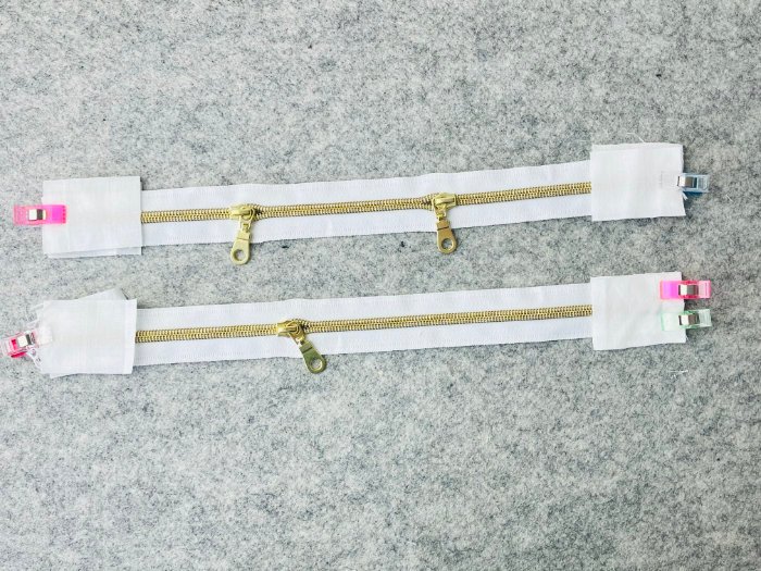 Sewing fabric zip tabs onto zipper ends