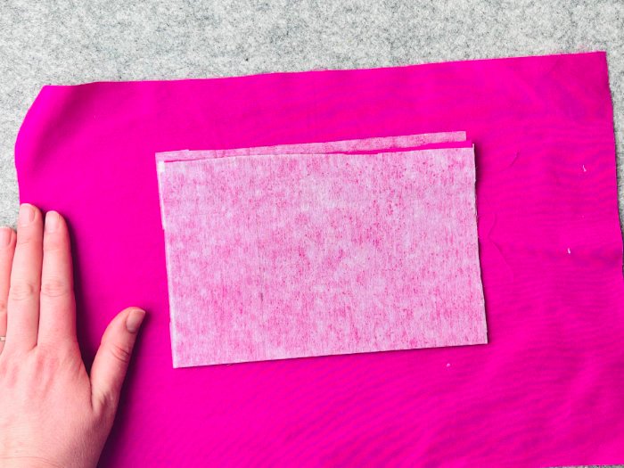 Folding up the lower pocket piece to create welt pocket