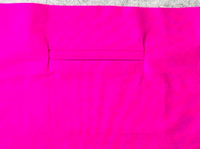 Topstitching welt pocket opening inside laptop bag lining