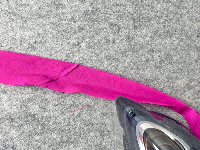 How to Make Bias Binding (Step-by-Step Tutorial for Beginners) Pressing bias strip in half with steam iron to prepare for single fold or double fold bias binding.