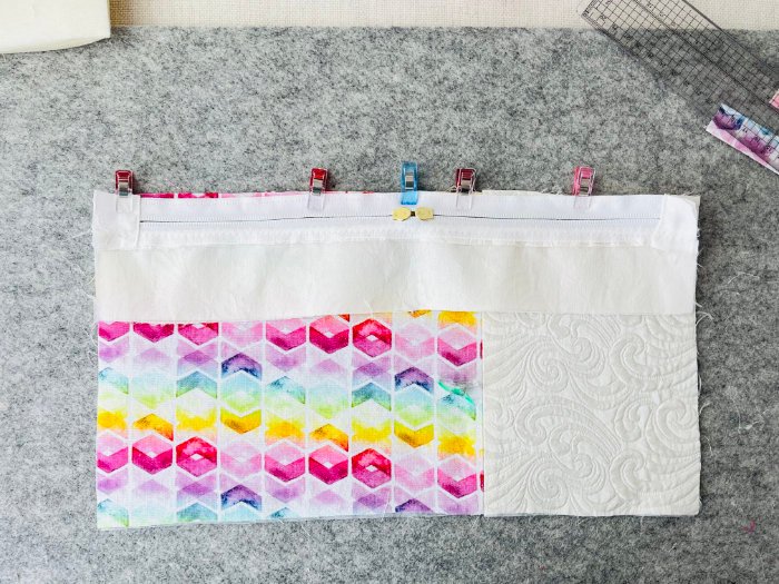 Joining upper and lower panels to create zipper pocket