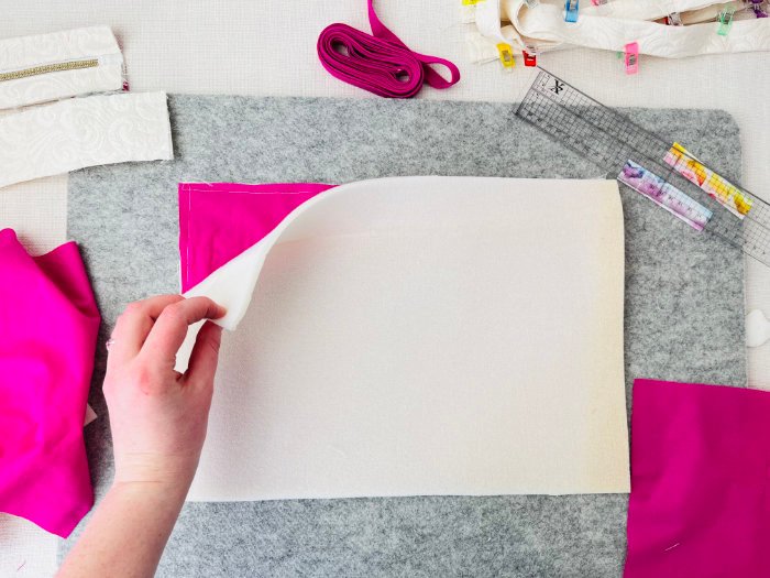 Layering foam padding onto laptop bag exterior panel