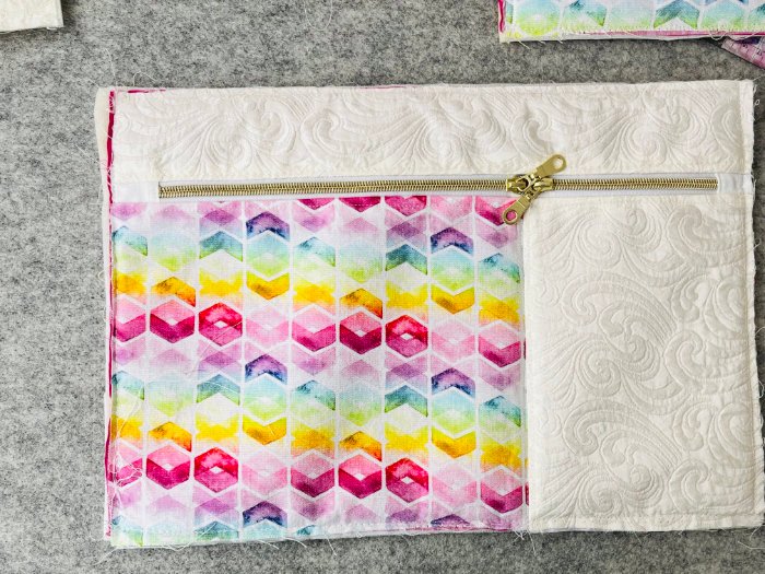 Dividing front pocket with stitch-in-the-ditch seam