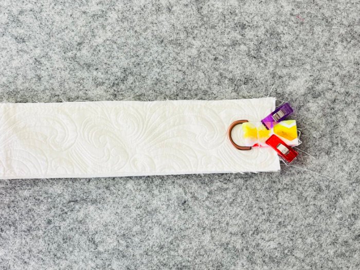 Securing D-ring tab into gusset seam