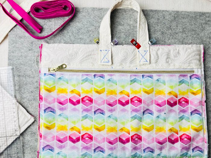 Attached handles on structured laptop bag