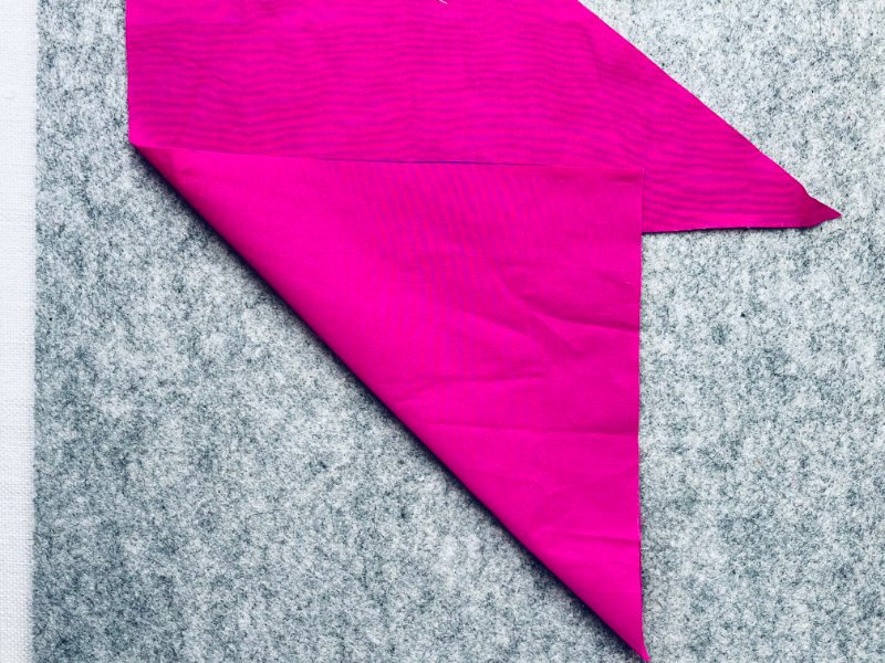 How to Make Bias Binding (Step-by-Step Tutorial for Beginners) Folding fabric corner to form a 45 degree angle for marking bias binding strips.