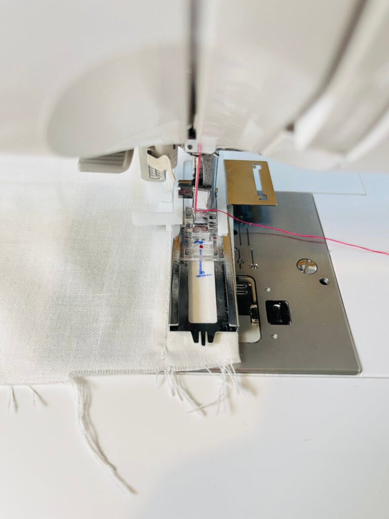 fabric positioned under buttonhole foot before stitching