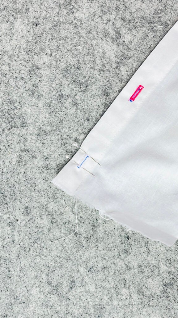 placing pins at ends of buttonhole before cutting