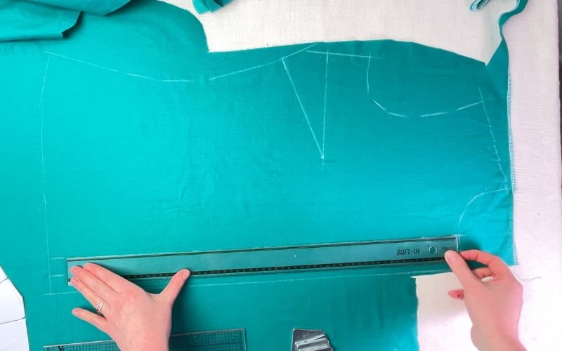 Marking button stand fold lines on fabric with ruler and soap on wrong side of shirt front