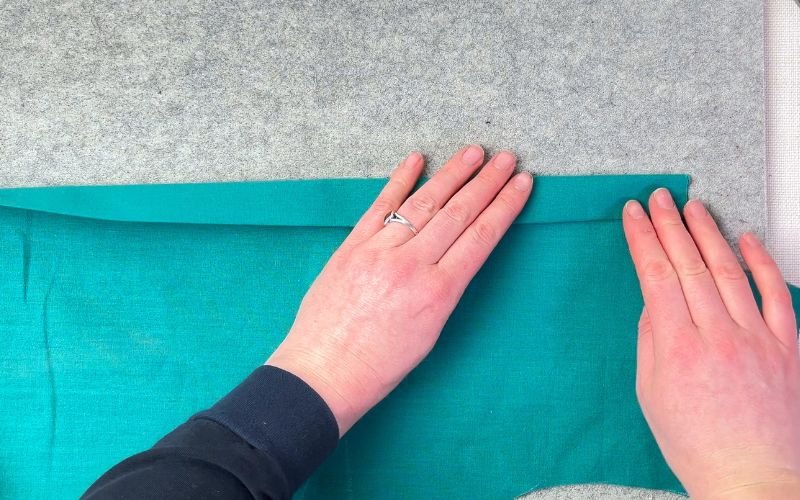 Folding and pressing button stand along marked lines to create crisp, structured edge