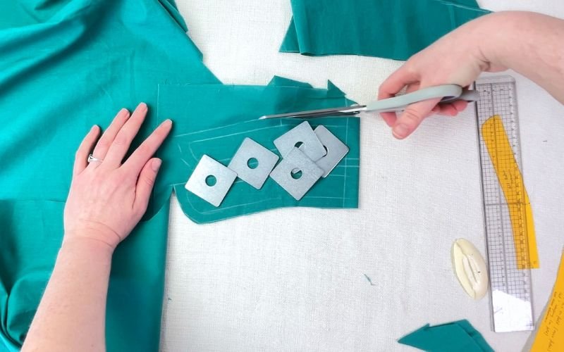 cutting shirt collar stand pieces on fabric fold following grainline
