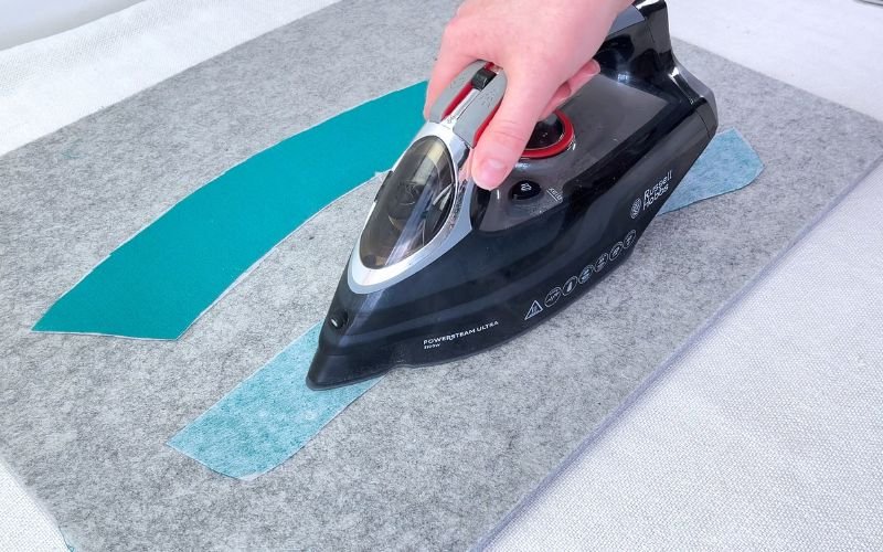 applying fusible interfacing to collar and collar stand pieces with iron