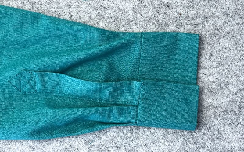 Close up of shirt sleeve cuff showing structured wrist finish and button closure