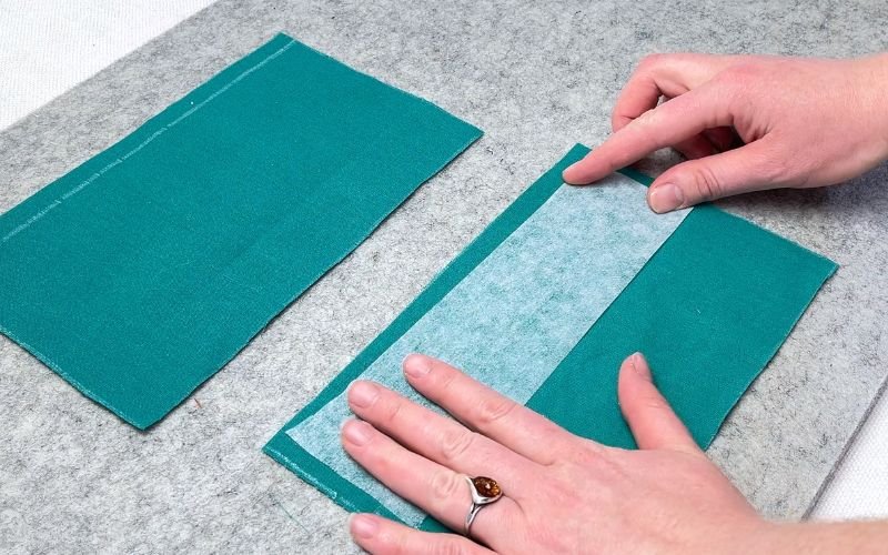 Applying fusible interfacing to shirt cuff fabric before sewing sleeve cuff