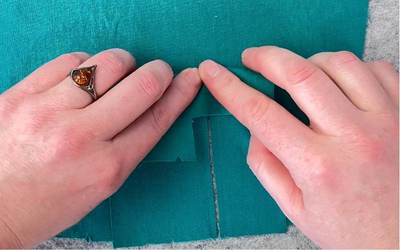 Folding the top of the seam before turning the sleeve placket to the right side