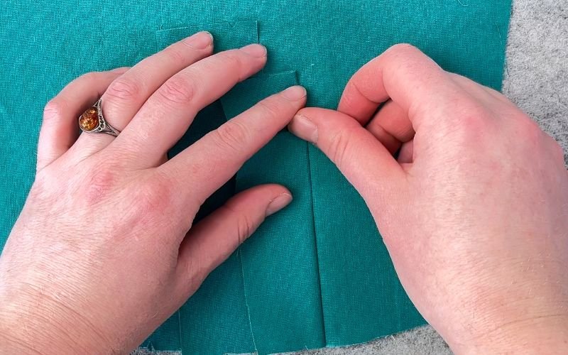 Folding the right side of the seam before turning the sleeve placket to the right side