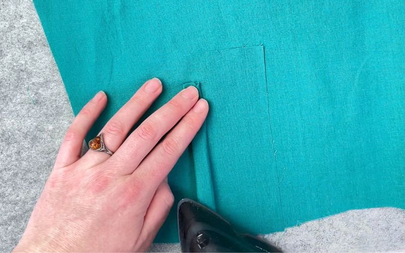 Folding the lower placket in place before pinning