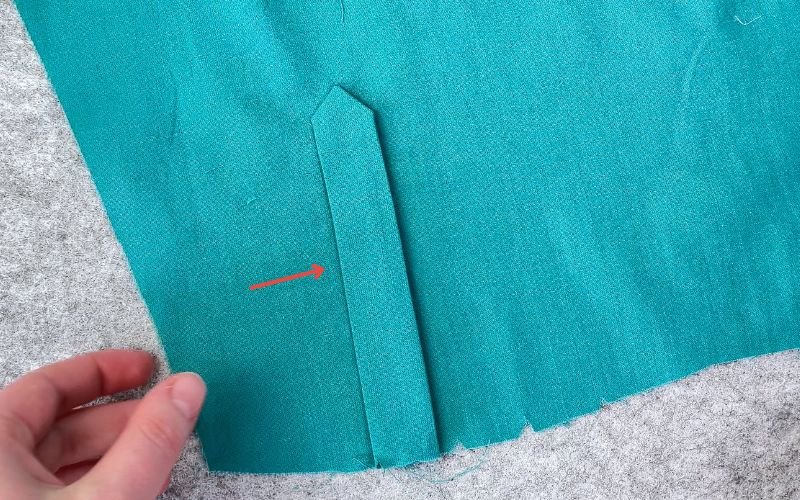 Folding outer sleeve placket in place before pinning
