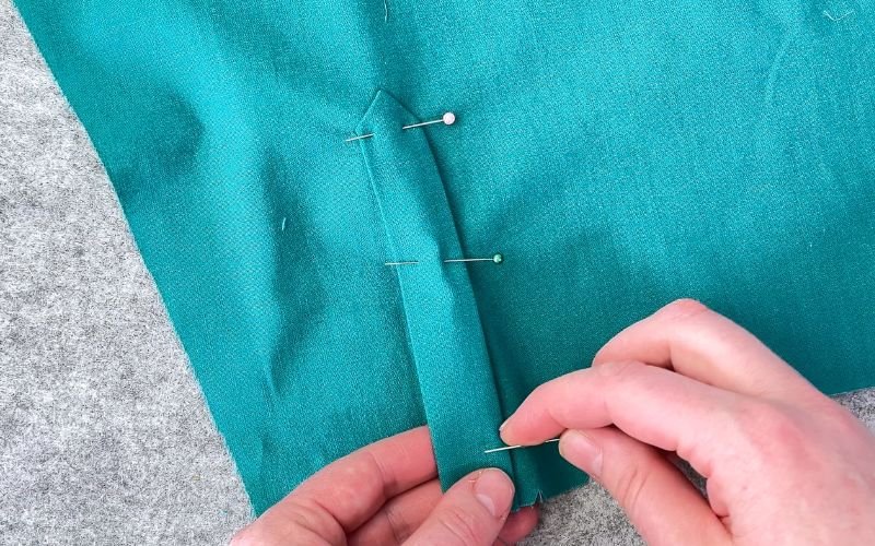 Pinning outer sleeve placket in place before sewing