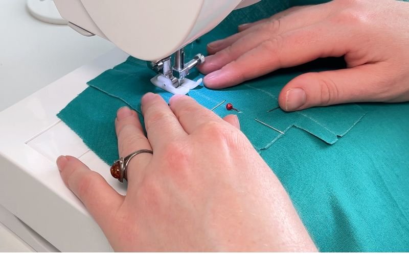 Sewing sleeve placket to sleeve along the slit line