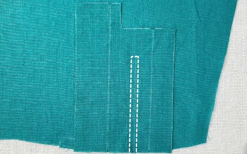 Sleeve placket attached to sleeve, showing the stitching line