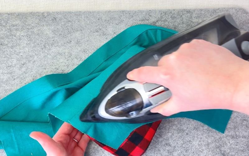 How to Sew Darts on a Shirt: Precise Marking, Transfer and Sewing Tutorial pressing dart over tailor’s ham to shape fabric smoothly