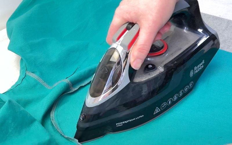 Pressing sleeve seam allowance towards shirt bodice