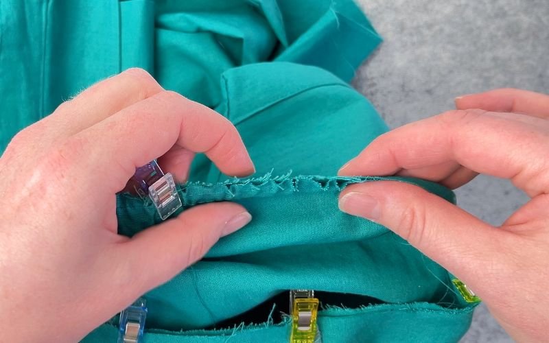 Pinning gathered shirt sleeve into closed armhole before sewing