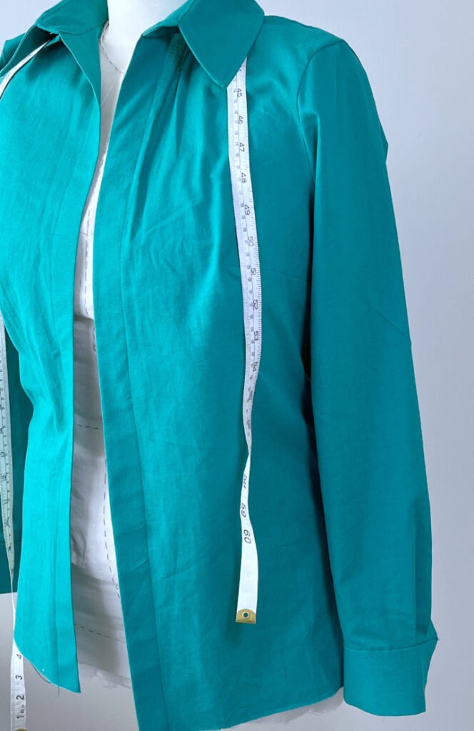 Close-up of finished shirt sleeve neatly attached to bodice with smooth sleeve crown and no puckering