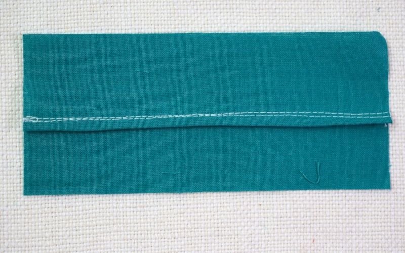 Different Types of Seam Finishes That Look Professional A detailed shot of a self bound seam finish, showing one wider seam allowance folded over and stitched down to enclose the narrower trimmed seam allowance
