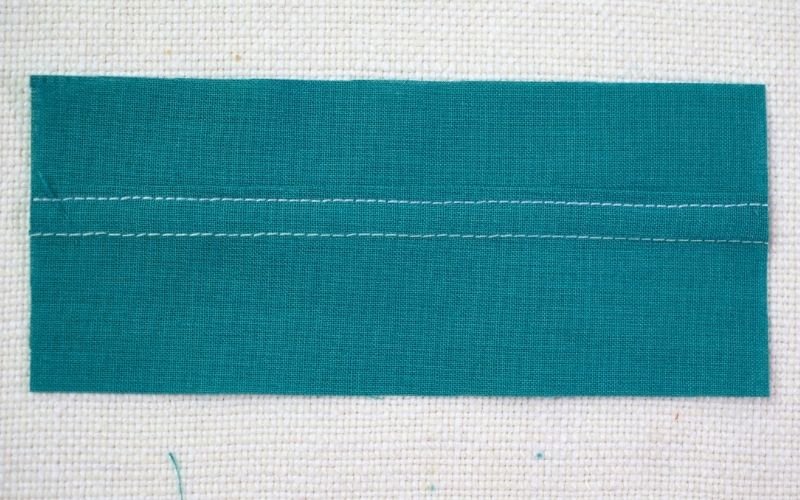 Different Types of Seam Finishes That Look Professional A close-up photograph of a durable run and fell seam, showing the trademark double topstitching line and the neatly enclosed raw edge for a strong finish.