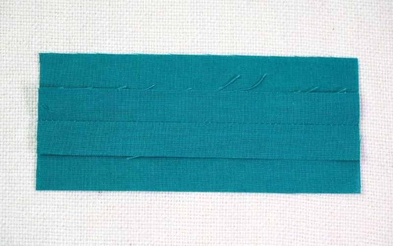 Different Types of Seam Finishes That Look Professional A close-up photograph of a simple plain seam on a fabric, showing the straightforward construction stitch with no additional raw edge treatment.