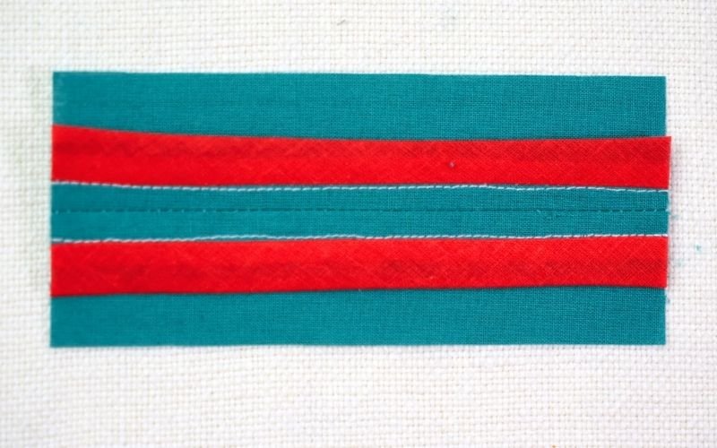 Different Types of Seam Finishes That Look Professional A detailed close-up of a Hong Kong seam finish, showing the raw edge bound with a contrasting double fold bias tape for a decorative and neat interior.