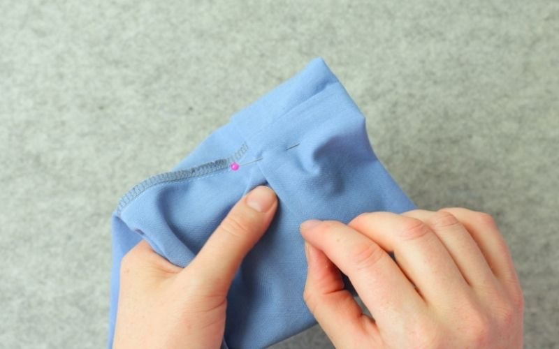 How to Sew Roll-Up Sleeves: Step-by-Step Guide Roll-up sleeve extension folded over the sleeve seam and being pinned in place