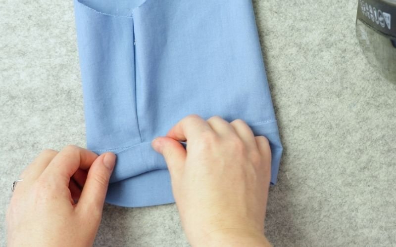 How to Sew Roll-Up Sleeves: Step-by-Step Guide Folding a sewn roll-up sleeve extension along the marked fold line
