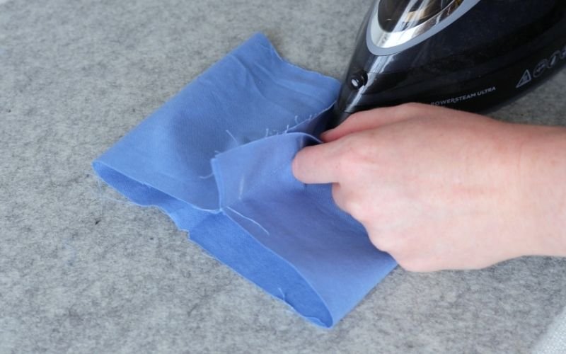 How to Sew Roll-Up Sleeves: Step-by-Step Guide Pressing the side seam of a fabric roll-up sleeve extension