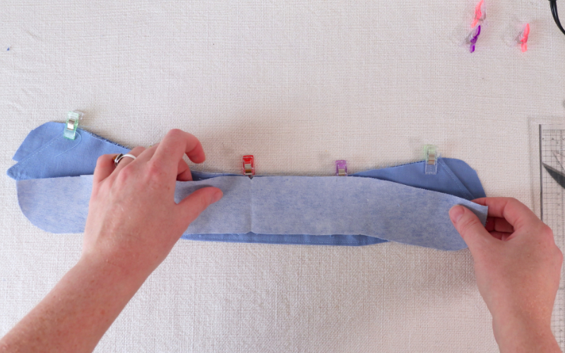 Sandwiching the collar between the two collar stand pieces before sewing