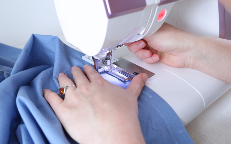 Sewing a buttonhole on the button stand of a handmade shirt dress