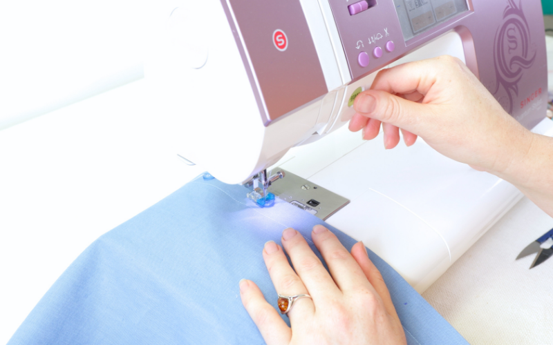 Sewing buttons on s shirt dress using a sewing machine