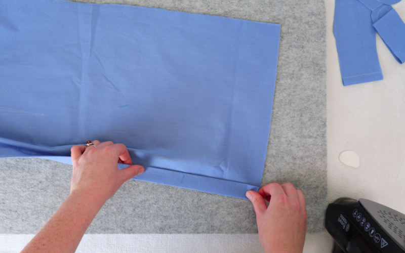 Folding and pressing the interfaced button stand on the front of a shirt dress